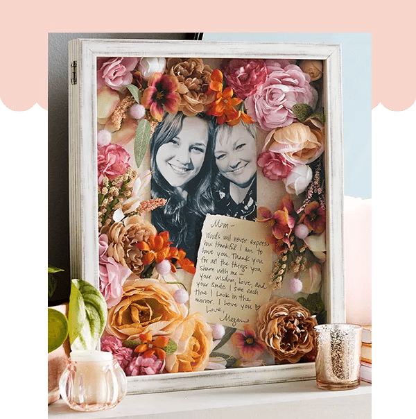 Shadow box containing photo of mother and daughter surrounded by flowers and Mother's Day note.